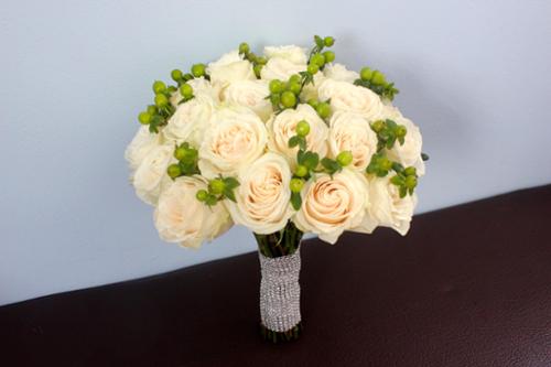 Cream vendela roses with hypericum berries make this simple and elegant bridal bouquet