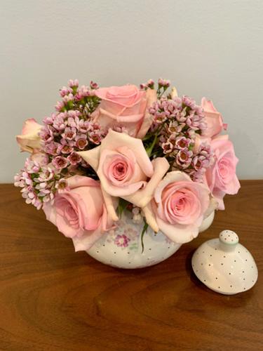 Part of the tea pots project, the combination of pink roses and pink wax flowers mimicked the tea pot design.